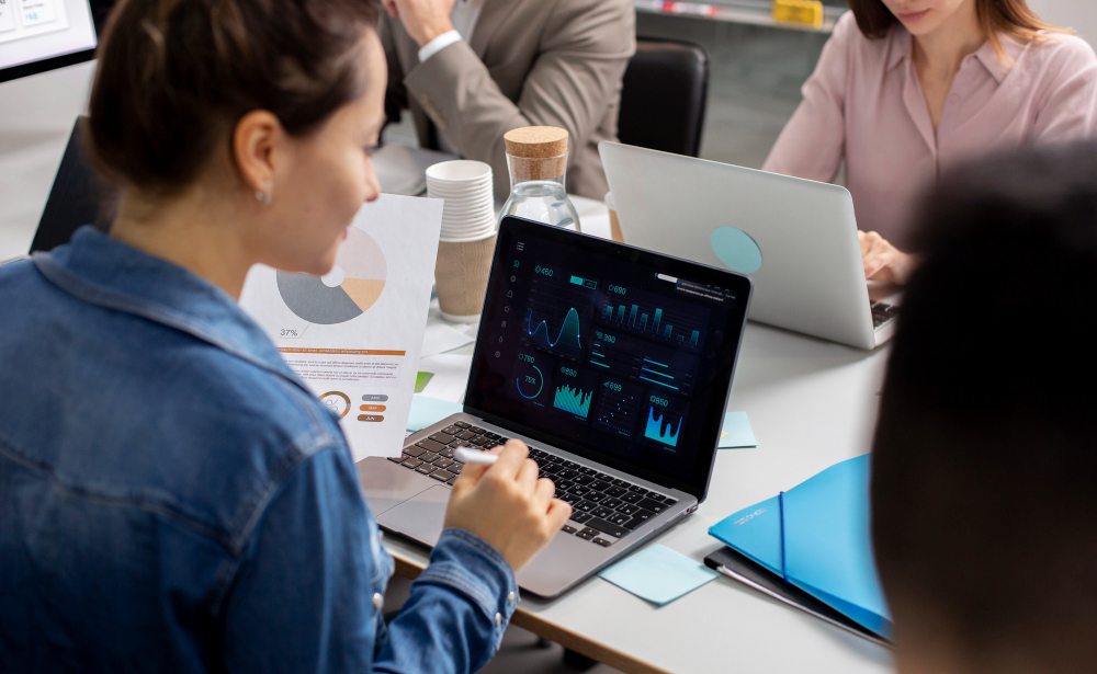 Team discussing charts on a laptop during a meeting
