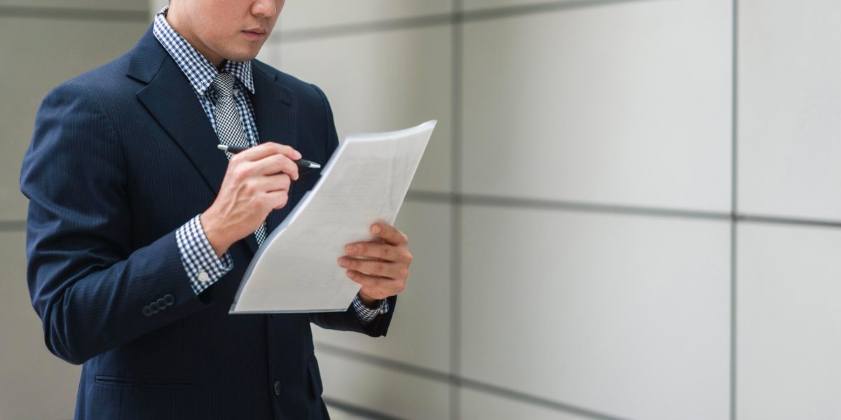 Business professional reviewing printed documents