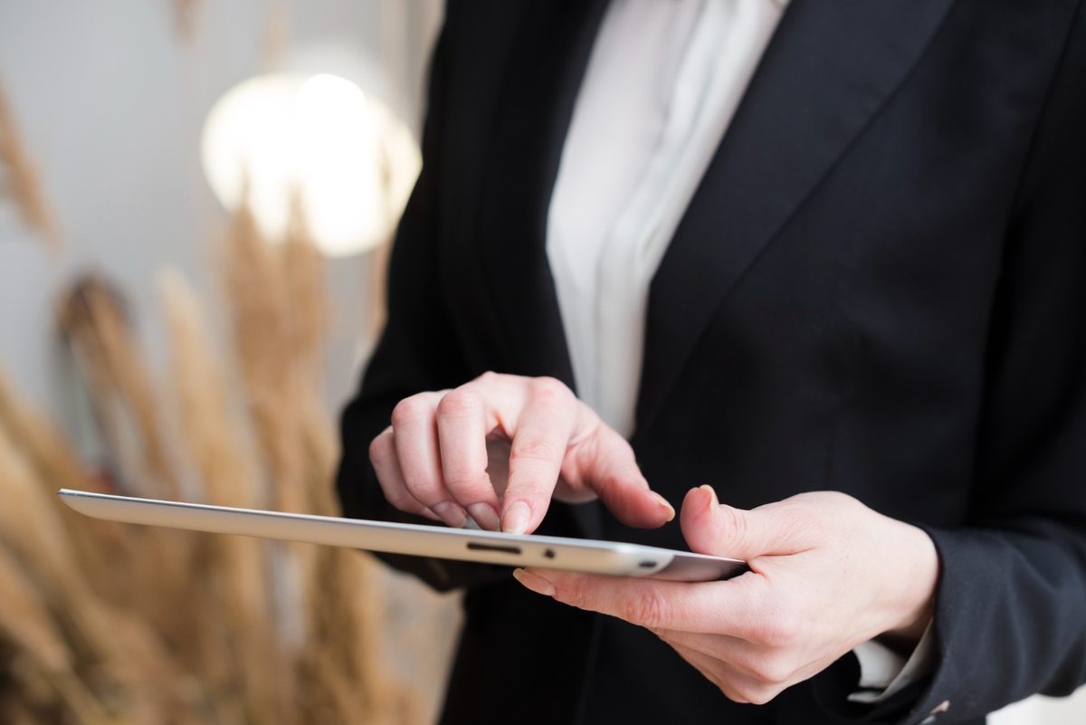 Person in a suit using a tablet