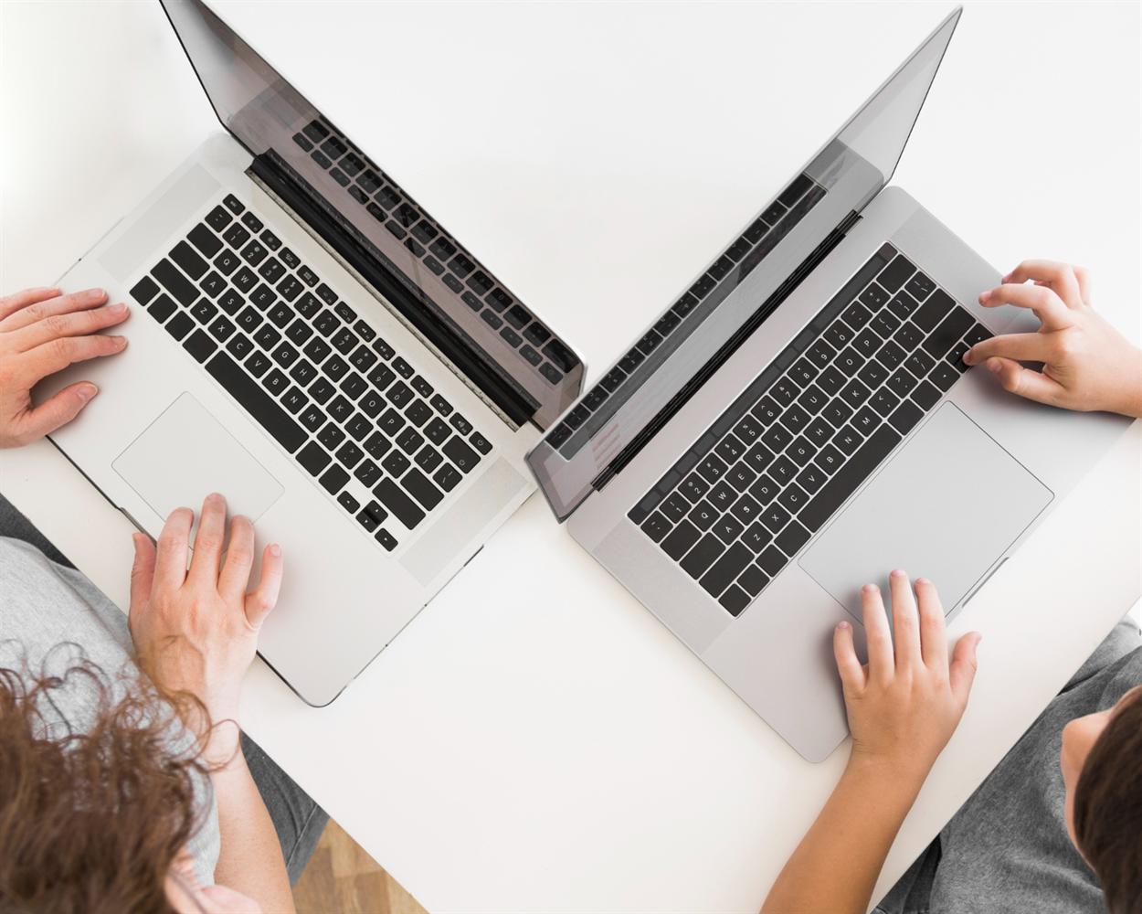 Two open laptops viewed from above for comparison
