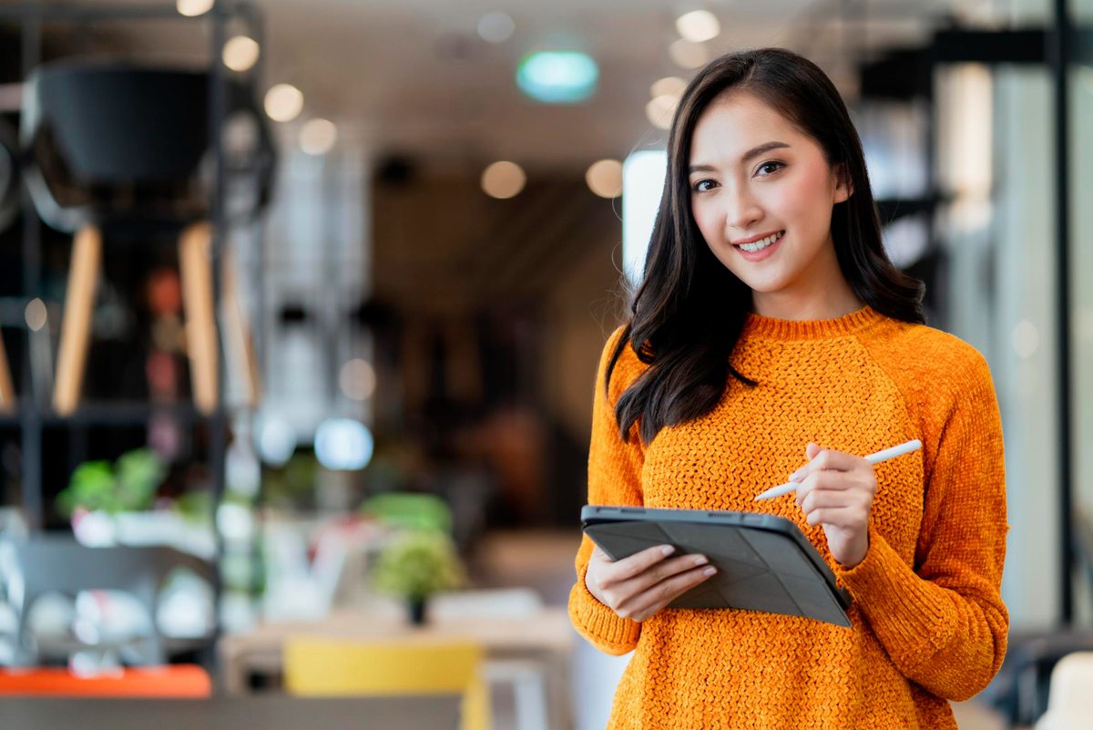Woman holding a tablet and stylus