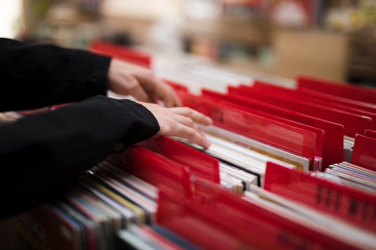 Hands browsing labelled folders in a filing cabinet