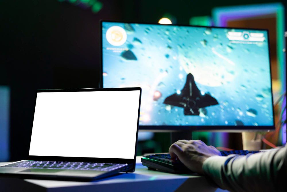 Gaming desk with a laptop, external monitor, and keyboard