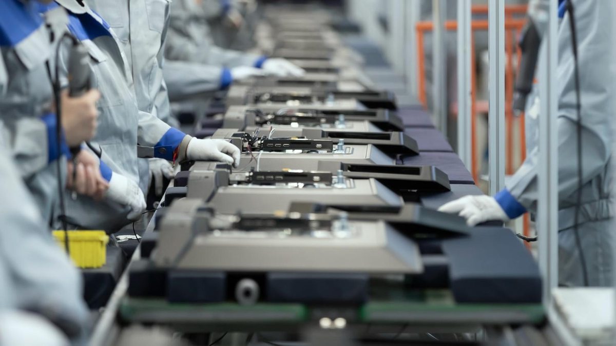 Workers handling products along a factory production line