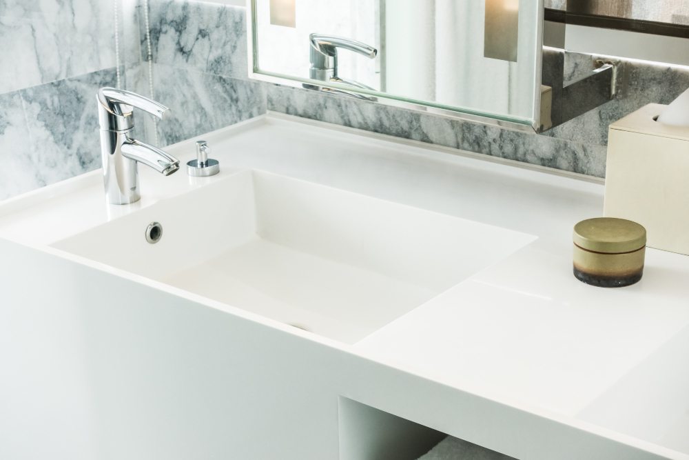 Rectangular white basin with a chrome tap and surrounding counter space