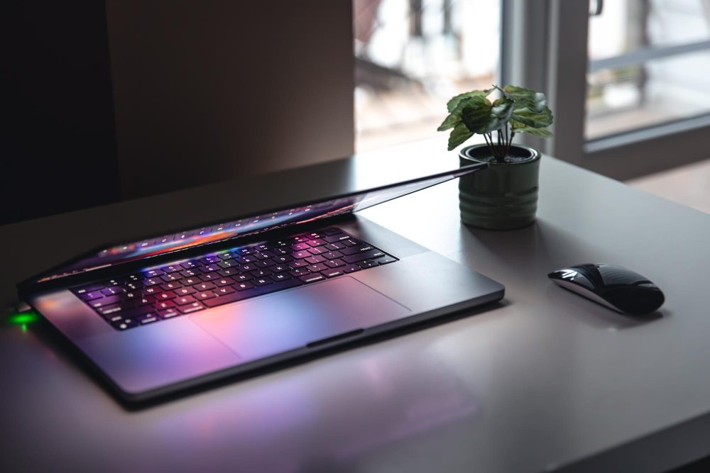 Laptop with an illuminated keyboard and external mouse