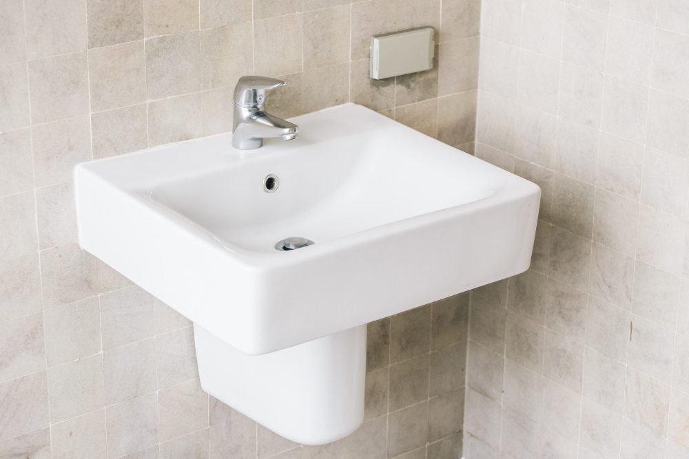 Rectangular wall-hung basin with a chrome tap