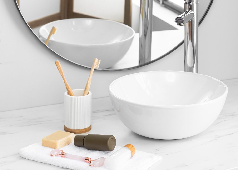 Round white countertop basin with a tall chrome tap